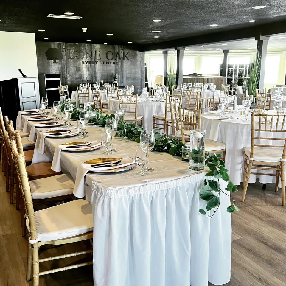 Tables dressed in black linen at the Fox Meadow Event Centre