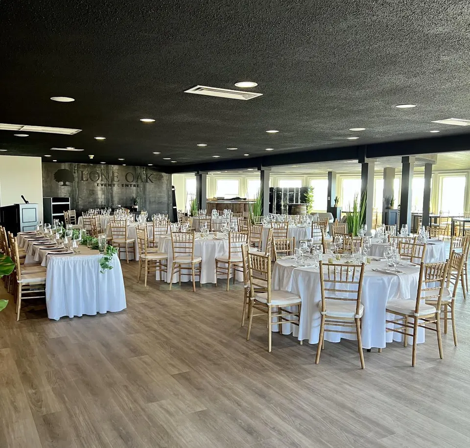 Long head table with greenery for a wedding at the Fox Meadow Event Centre
