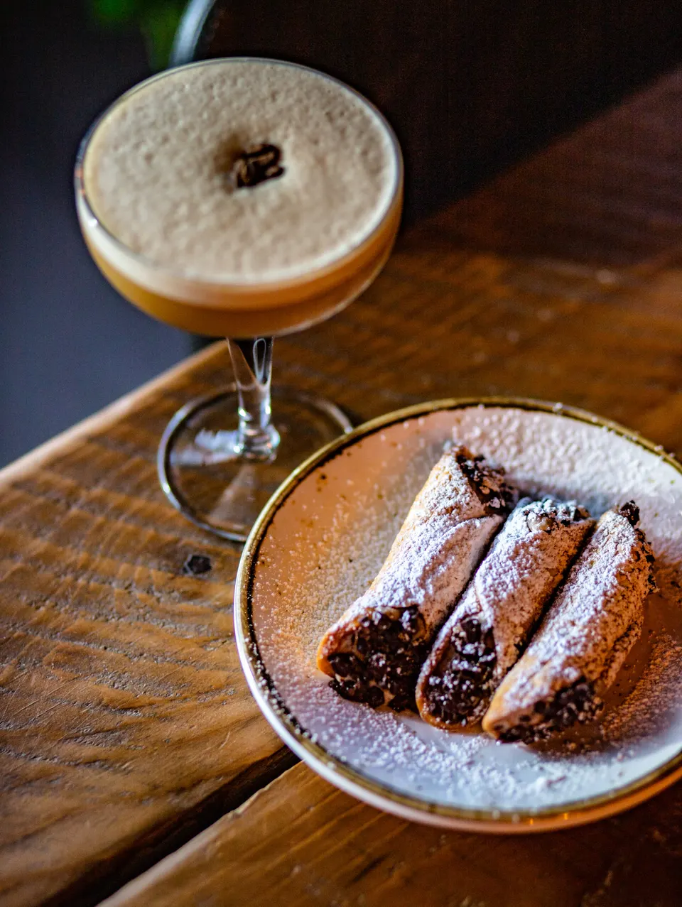 Espresso martini and dessert on a wooden table at the Lone Oak Brewpub